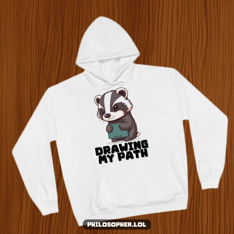 Funny hoodie with a determined badger concentrating on sketching on a tiny chalkboard, radiating artistic focus and warmth.