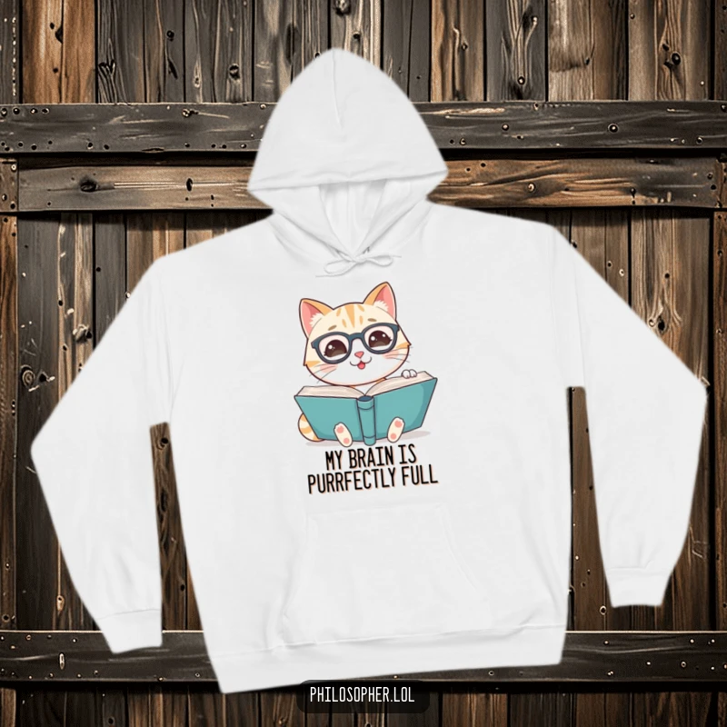 Funny hoodie depicting a smiling cat wearing spectacles, reading a large book, perfect for cozy reading sessions.